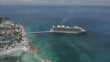 large caribbean cruise ship at pier of little stirrup cay in bahamas