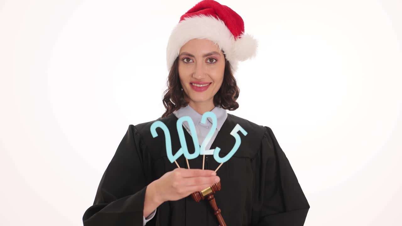 Judge in Santa hat holding 2025 sign