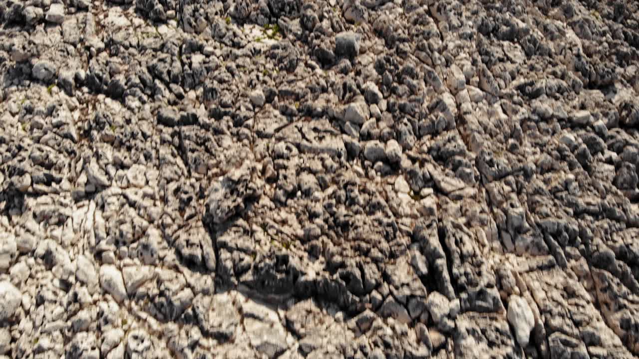 Rock Surface of Paralia Emplisi Beach, Overlooking The Dense Forest of Kefalonia, Greece- Overflying Aerial Shot
