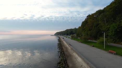 aerial flying over breakwater with calm waters in seaside boulevard of gdynia