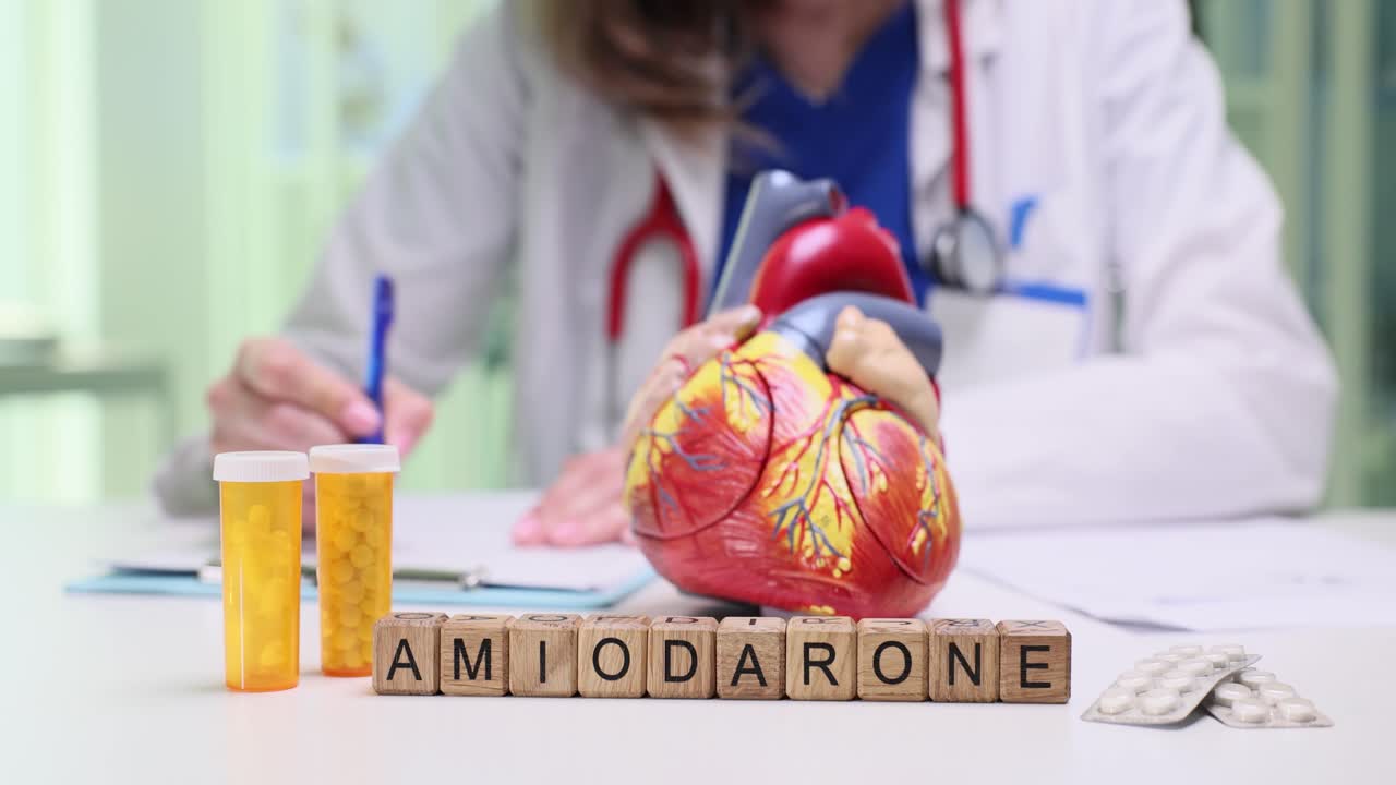 Doctor with Amiodarone medication and heart model