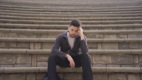 the young man was alone in the open air, thinking and frustrated.