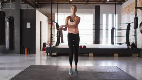 Video-of-fit-caucasian-woman-jumping-on-jumping-rope-at-gym