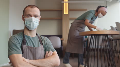 portrait of waiter wearing medical mask and gloves