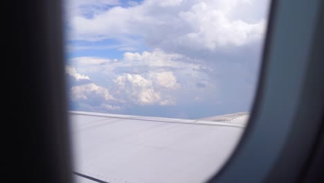 looking outside airplane window flying through beautiful skies