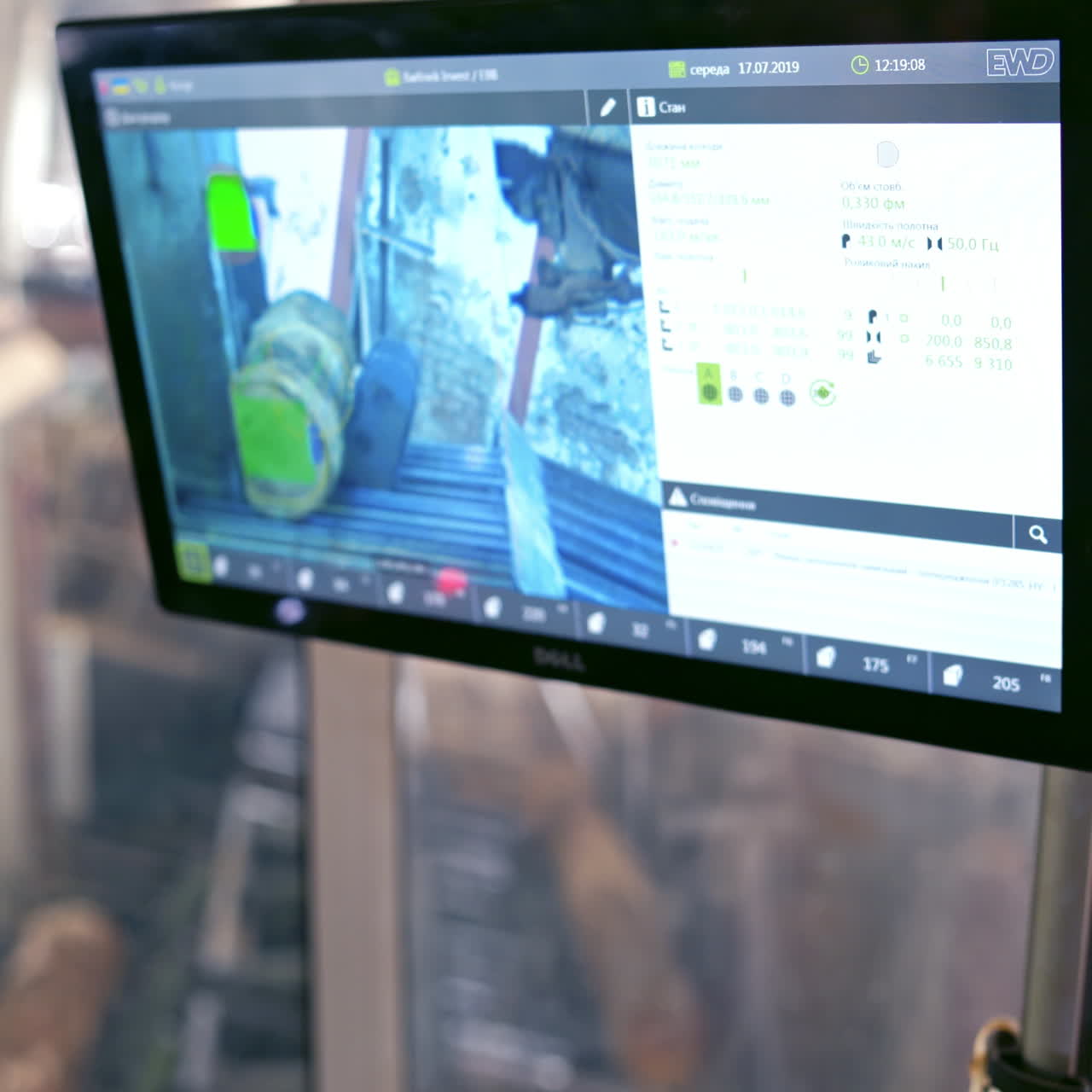 Modernized woodworking plant. Worker controls the work of automated machinery through the monitor.