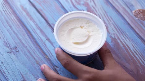 person eating ice cream from a cup