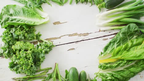 video of fresh salad leaves with copy space on white rustic background