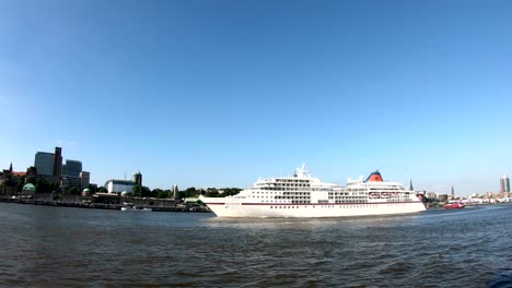 cruise liner in hamburg on departure, elbe and cityscape,