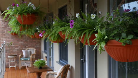 balcony with lush hanging flower baskets and outdoor furniture