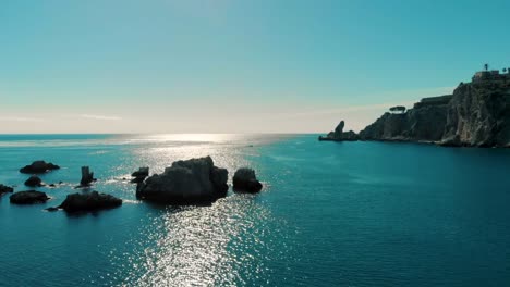 aerial view of the sparkling blue ocean with rocky cliffs, reflecting coastal light. a serene and peaceful scene captured from praia do camilo, portugal, offering stunning natural beauty