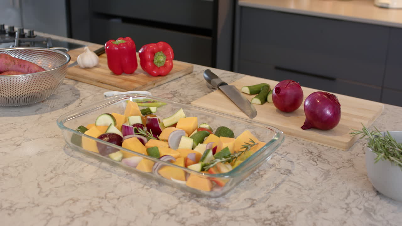 Preparing vegetables for cooking, kitchen counter with fresh produce and knife, at home