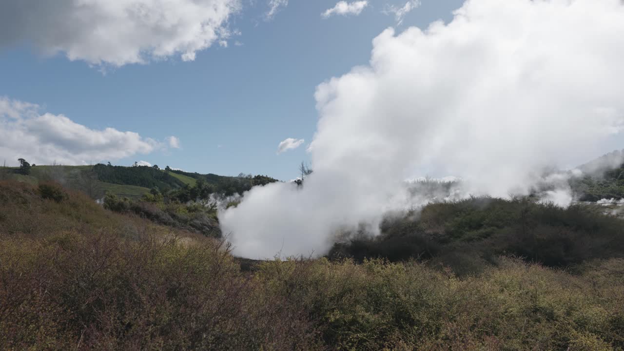 Steam coming from the ground in a geothermal active area on a sunny day in Craters of the Moon, Taupo, New Zealand.