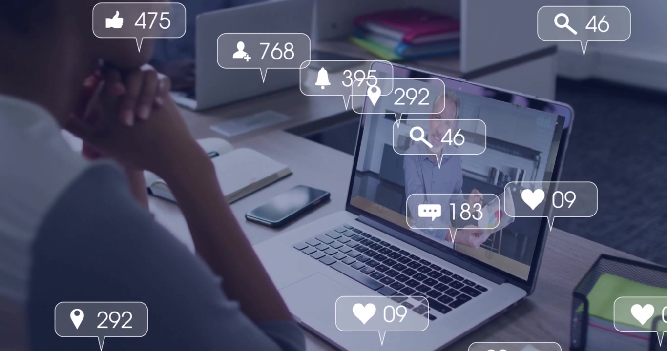 Presenter gesturing sending marketing icons rising and thinning around PC showing engagement peak