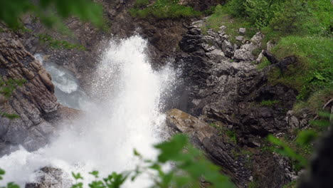 top-down slow motion of waterfall splashing on hard rock and granite