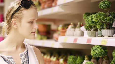 attractive woman choosing potted plants