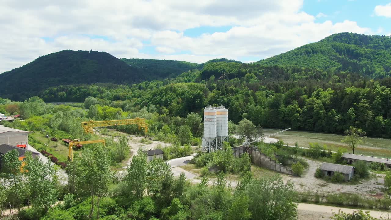 Aerial view of city outskirt with industry and mountain range near Celje Slovenia