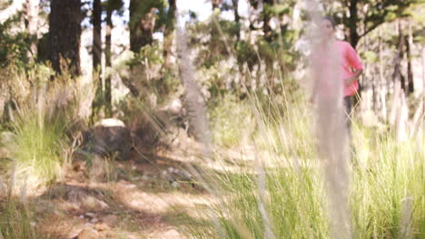 woman jogging through forest