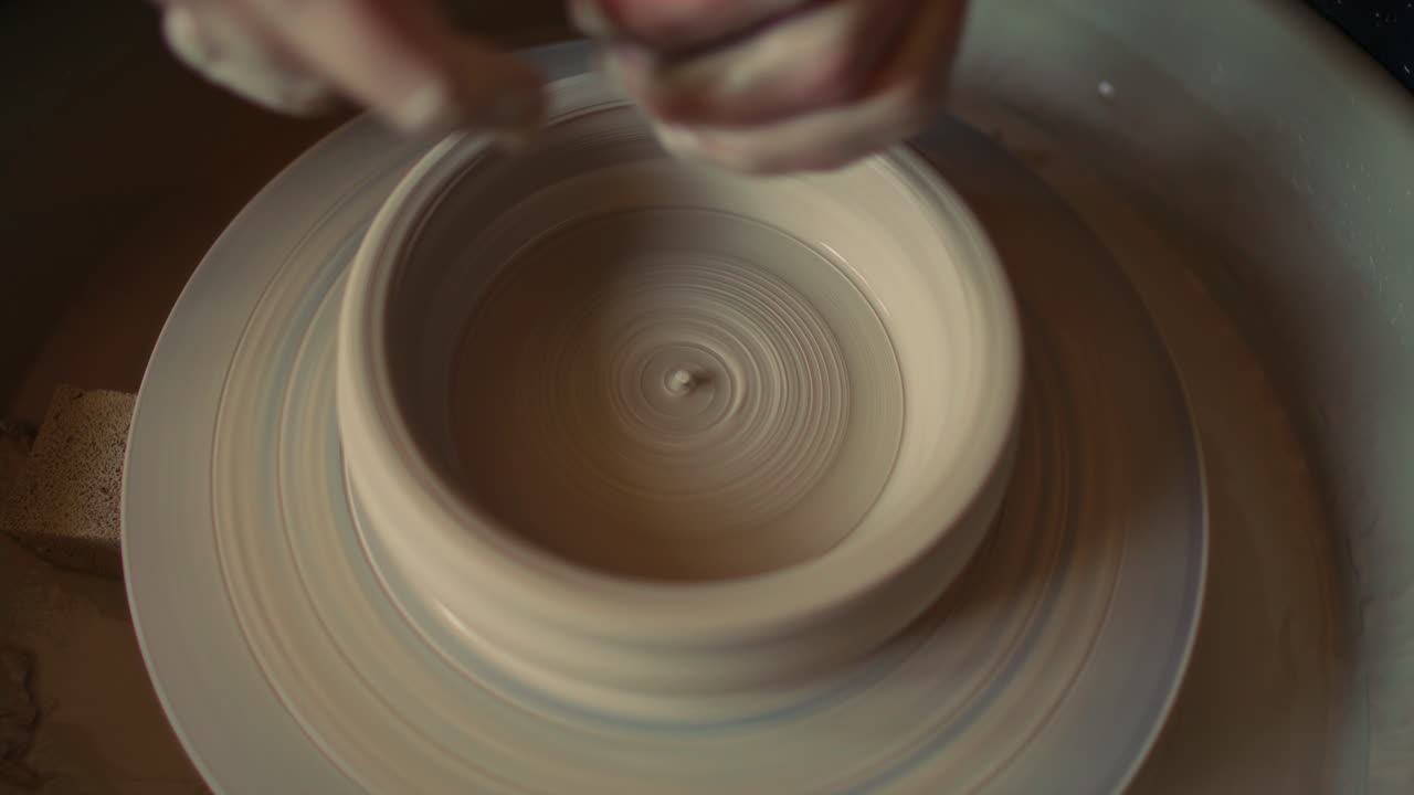 Close Up of Refining Inner Wall of Clay Bowl on Pottery Wheel