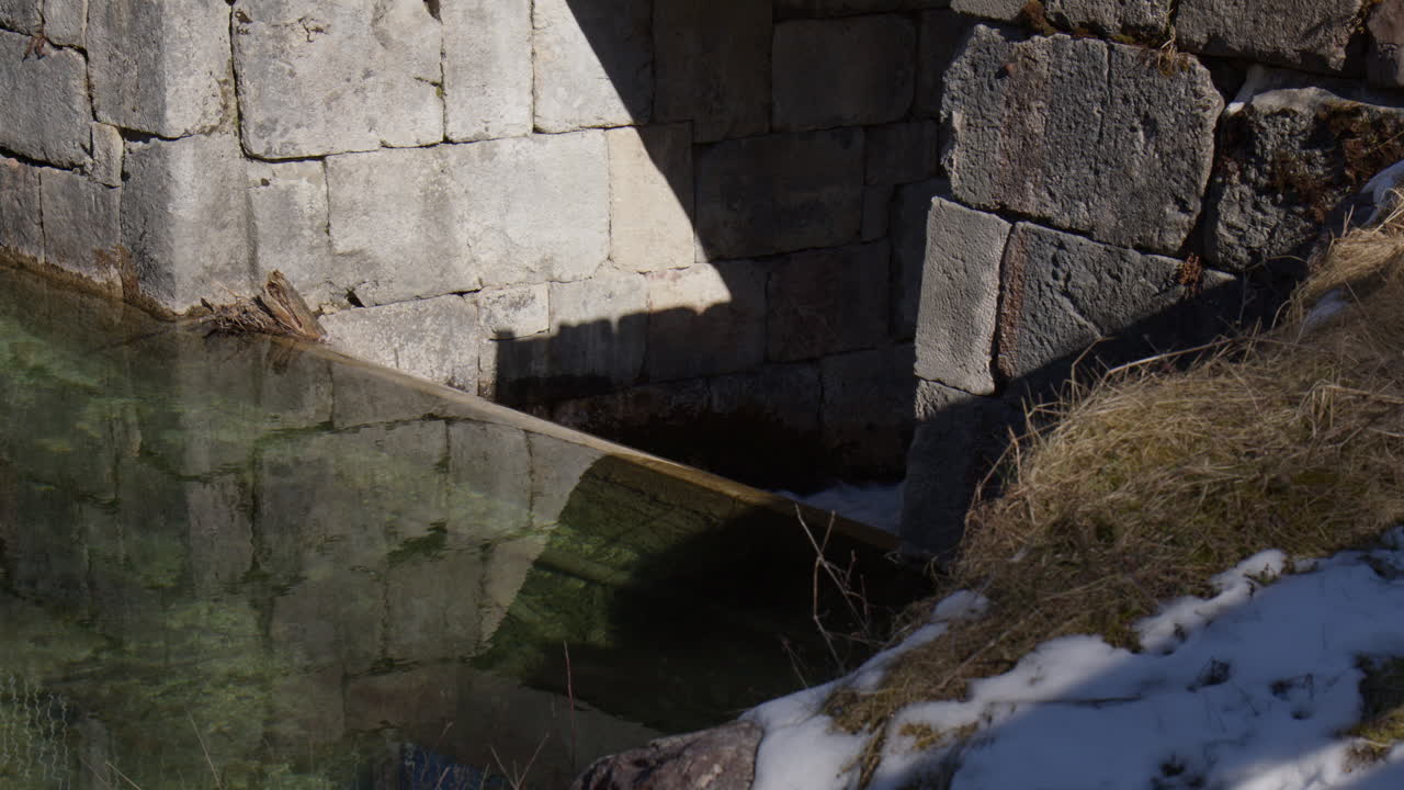 Stream Flowing Between Concrete Walls Over A Mountain Village In Germany. Close-up Shot