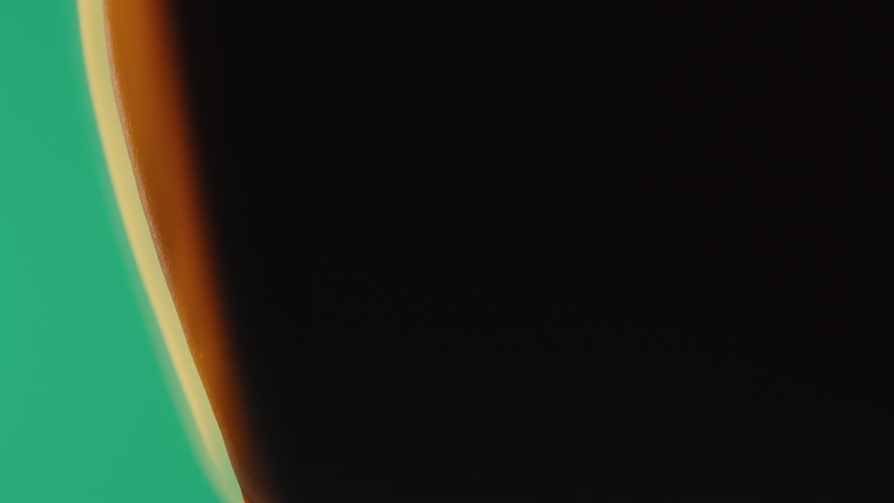 Close-up view of an orange object against a green background