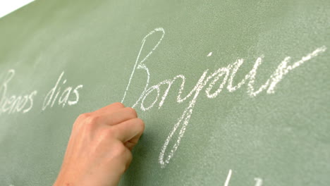 in slow motion french word written on green board