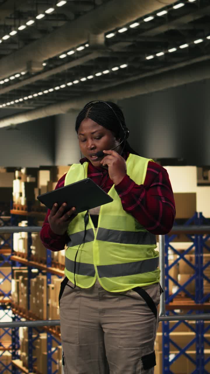 Vertical Video African american worker, handling customer support, headset and phone call