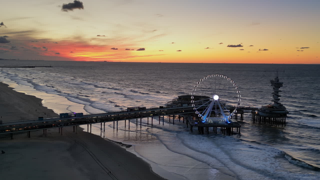 The Hague, Netherlands - November 21, 2024: Aerial drone view of the Scheveningen Pier and Ferris Wheel at the Dutch North Sea Coast