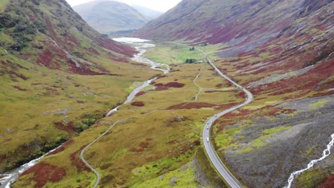 Aerial-View-Over-Winding-A82-Road-Through-Glencoe-Valley-Floor