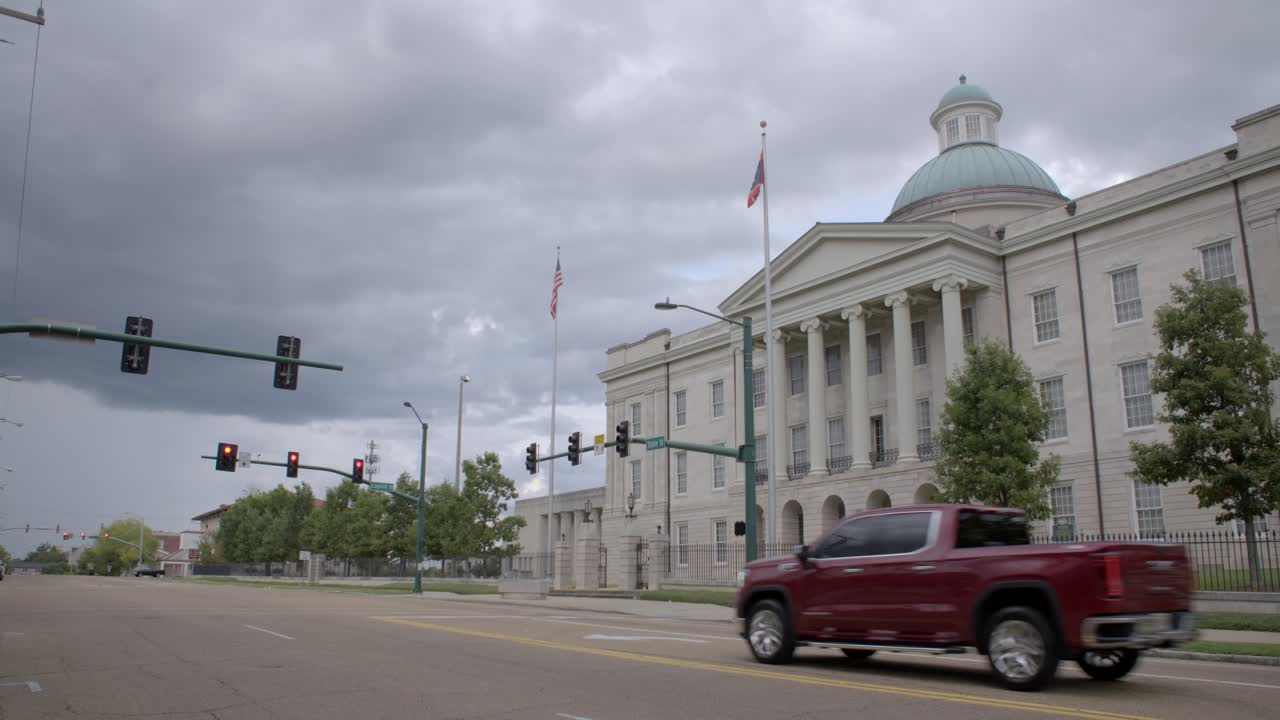 Wide - Pan: New Mississippi state flag, Magnolia Flag, flying at the Old State Capitol in Jackson, MS.