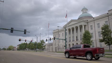 wide - pan: new mississippi state flag, magnolia flag, flying at the old state capitol in jackson, ms.