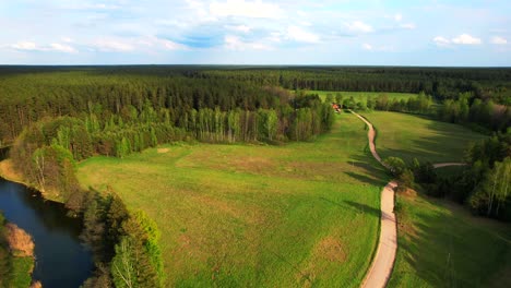 Dirt-road-leading-to-the-wild-forest-and-river