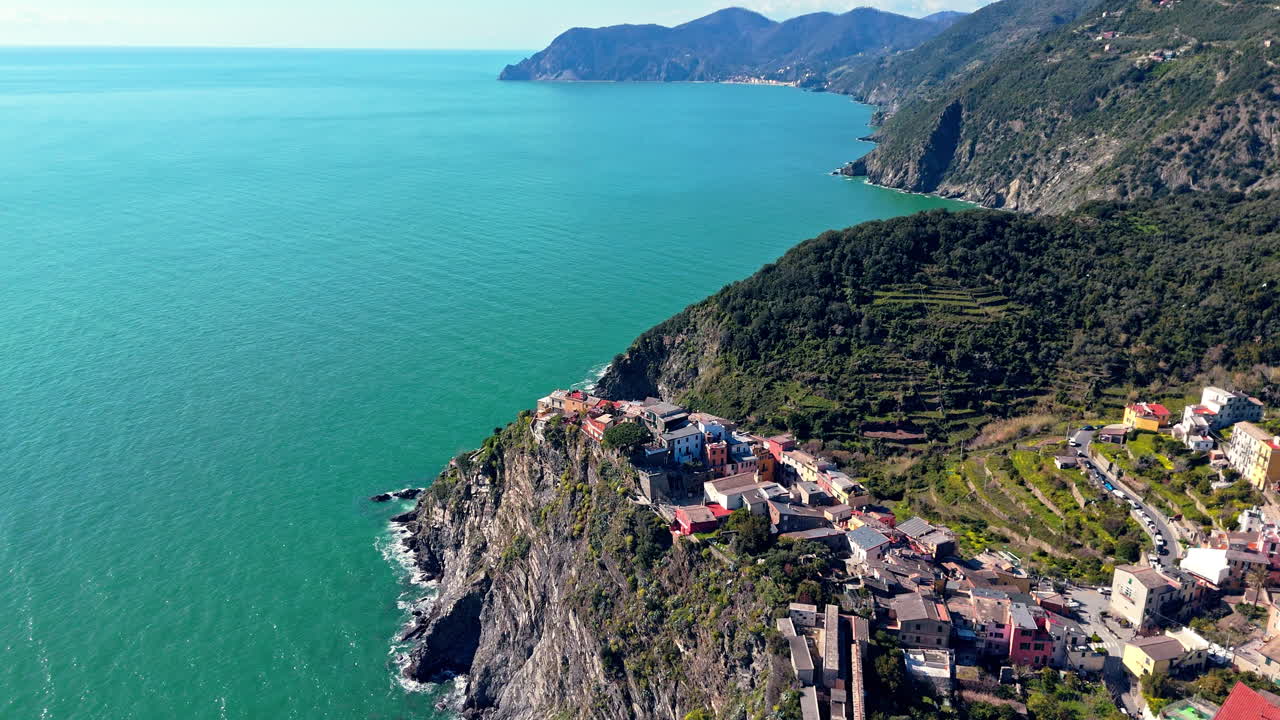 Corniglia, cinque terre, with clear blue waters and lush hills, aerial view