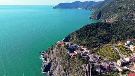 corniglia, cinque terre, with clear blue waters and lush hills, aerial view