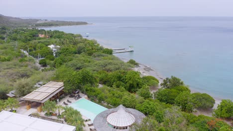 Aerial-View-Of-Hotel-And-Villa-Overlooking-Caribbean-Sea-By-The-Bahia-De-Ocoa