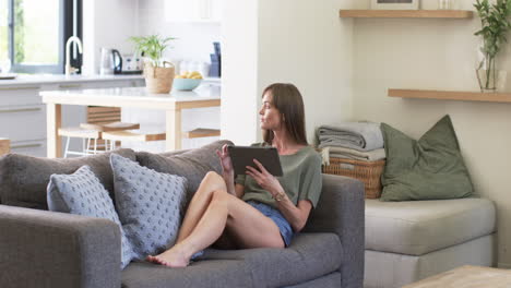 middle-aged caucasian woman enjoys leisure time at home, with copy space