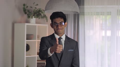 Young-man-wearing-job-suit-gives-confident-thumbs-up,-positive-feedback