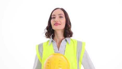 woman in safety vest and hard hat posing
