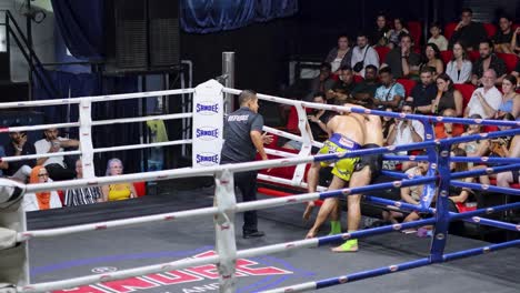 two fighters engage in a muay thai match