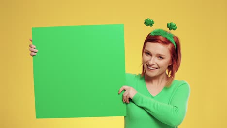 portrait of woman holding green banner with copy space