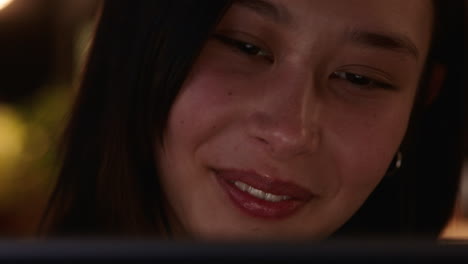 close up portrait beautiful asian woman using tablet computer watching movie laughing enjoying comedy entertainment relaxing at home