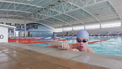 Swimmer-coming-out-of-water-and-looking-at-camera