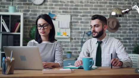 two colleagues working together at a desk