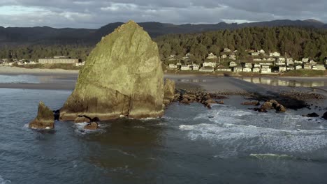 haystack rock at cannon beach in oregon, sunset over ocean, aerial view