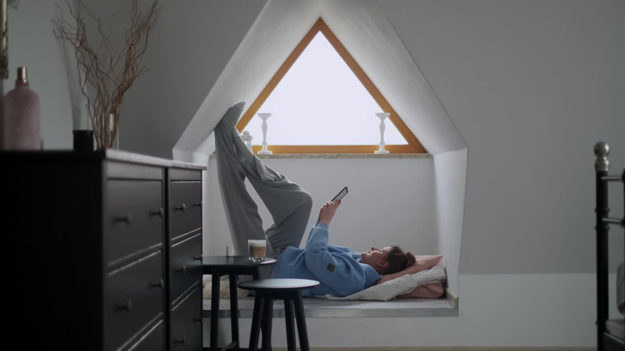 Woman Relaxing in an Attic Window Seat
