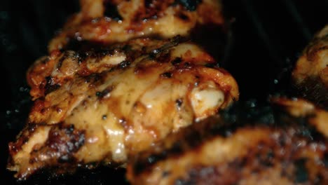 delicious juicy chicken thighs cooking on bbq