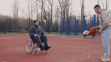 young disabled man playing to basketball with his friend 2