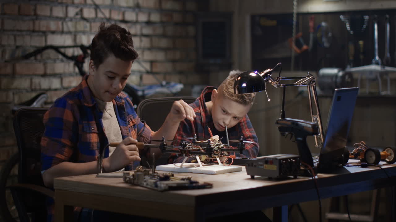 Boys Building a Drone in a Home Workshop