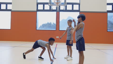 in school gym, boys exercising and playing basketball, staying active and healthy