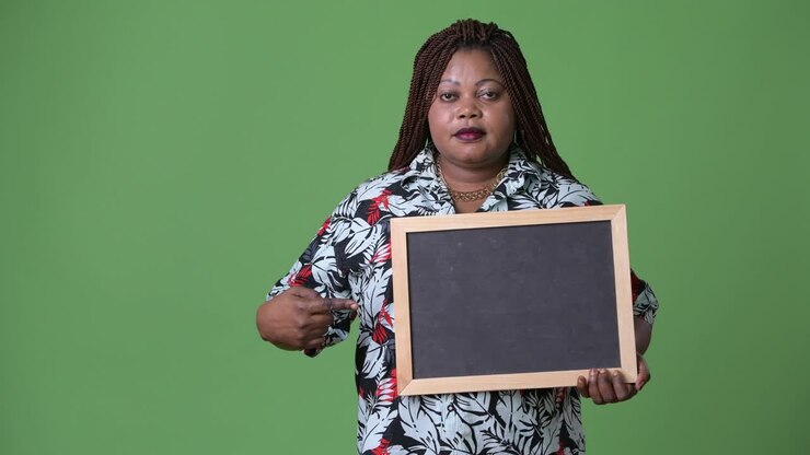 Overweight beautiful African woman against green background